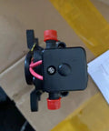 Top view of a 12V water pressure diaphragm pump with red connectors, suitable for RV, boat, caravan marine use, 35 PSI.