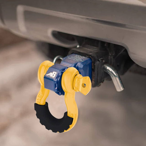 Beefed-Up Heavy Duty Three Quarters Inch D Ring Shackles Set Forged Steel Tow And Winch Shackles Four Point Seven Five Ton Load Capacity Two Pack Off Road Recovery Gear Yellow Powder Coat With Isolators attached to vehicle hitch