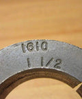 Close-up of Dodge Taper-Lock Bushing 1610 X 1-1/2 KW, PN 117163 with engraved size and part number on metal surface.