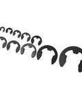 Different sizes of black carbon steel external snap rings from 580 Piece E Type Retaining Ring Set With Black Carbon Steel External Snap Rings 1.5mm To 10mm Range In Industrial Fastener Storage Box Easy Install Clips For Hardware Repairs DIY Friendly shown on white background
