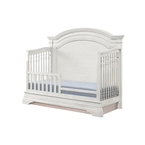 Solid Wood Toddler Guard Rail for Convertible Crib to Toddler Bed, 54.81 Inch Wide, Brushed White Finish, shown on crib