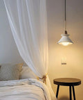 Modern E26 Concrete Pendant Lights Set With Industrial Cement Vibe illuminating a Nordic-style bedroom with minimalist decor.