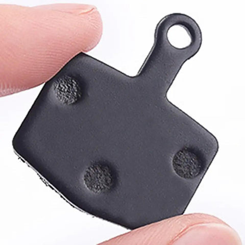 Organic Sintered Metal Disc Brake Pads For Mountain, Trail, And Urban Riding, 26mm by 20mm size, resin-metal compound close-up
