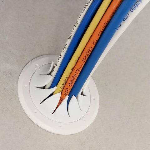 Construct Pro Speedy’Z Spring-Lock 2-inch Cable Pass-Through Port, white round wall plate with multiple cables.