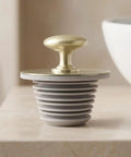 Happyyami Bathtub Drain Stopper Rubber Plug with Handle Leak Proof Seal on a countertop with a smooth design.