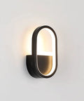 Modern Geometric Wall Sconce With 15 Watt Led Bulb And Sleek Aluminum Iron Frame For Bedroom Nightstand Setup Or Living Room Accent Lighting Super Chic Home Vibes Easy Wall Mount Soft Glow Lamp mounted on a wall with soft glow.
