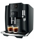 Next Level 5th Gen Automatic Smart Coffee Machine Bundle Featuring Piano Black Finish Plus Matching Glass Milk Frothing Container For Hella Smooth Lattes Bold Espresso And Quick Cappuccino Prep showcasing JURA E8 with double espresso cups.