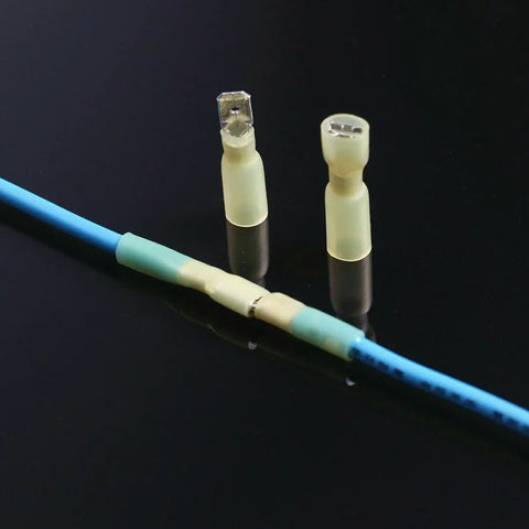 Rock-solid 100 Piece Electrical Spade Wire Connector Kit Featuring Durable Heat Shrink Male And Female Tips For All Your Wiring Jobs With Super Secure Grip. Male and female heat shrink spade connectors on blue wire.