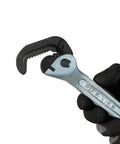 Top Shelf Nine Inch Compact Pipe Wrench Built Like A Tank For Killer Grip On Half To One Inch Fittings Chrome Plated Tough As Nails Construction For Cramped Plumbing And Hvac Tasks Ready To Roll, held in black glove.