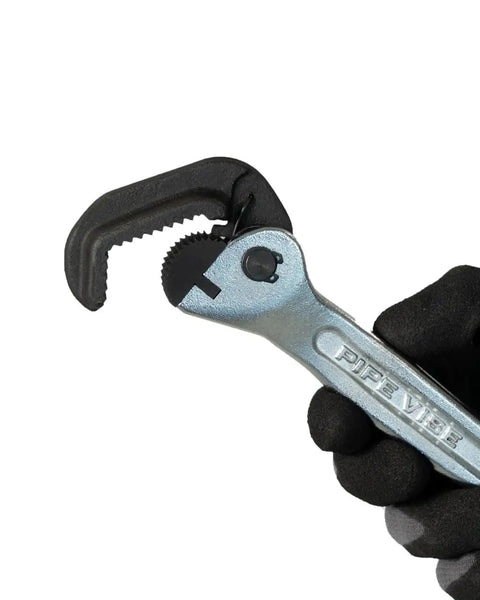 Top Shelf Nine Inch Compact Pipe Wrench Built Like A Tank For Killer Grip On Half To One Inch Fittings Chrome Plated Tough As Nails Construction For Cramped Plumbing And Hvac Tasks Ready To Roll, held in black glove.