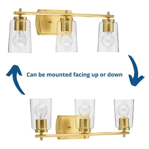 Adley Collection 3 Light Clear Glass Bath Vanity Light In Satin Brass, shown mounted facing up and down