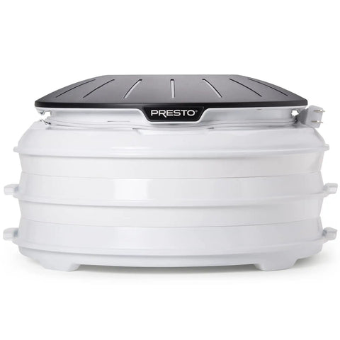 Electric Food Dehydrator With Four Stackable Trays And Top Mounted Fan, compact design with a black lid and white base.