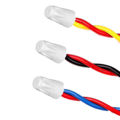 Ceramic wire connector caps on three twisted wire pairs: red–yellow, red–black, red–blue.