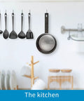 Kitchen scene showing utensils and pan hanging from wall, illustrating concept for Heavy Duty Steel Utility Hooks 2 Pack For Garage Wall Mount Storage Garden Tool Organizer Anti Slip PVC Coated Hooks Holds 50lbs Each Easy Install Durable Storage Hangers.
