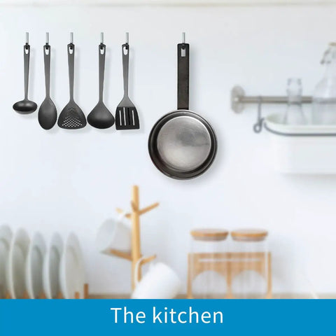 Kitchen scene showing utensils and pan hanging from wall, illustrating concept for Heavy Duty Steel Utility Hooks 2 Pack For Garage Wall Mount Storage Garden Tool Organizer Anti Slip PVC Coated Hooks Holds 50lbs Each Easy Install Durable Storage Hangers.