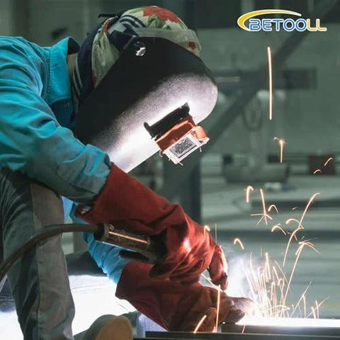 Front view of welder wearing protective mask and blue sleeves welding metal; BETOOLL logo in top-right.