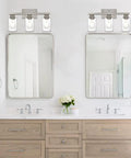 Three Light Wall Mount Bathroom Light Fixture In Brushed Nickel Finish With Seeded Glass Shade above double vanity sinks