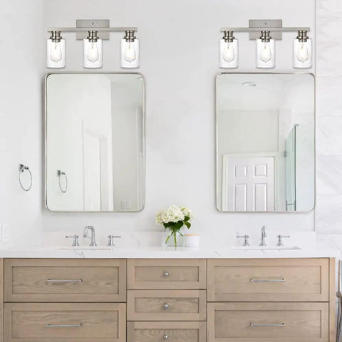 Three Light Wall Mount Bathroom Light Fixture In Brushed Nickel Finish With Seeded Glass Shade above double vanity sinks