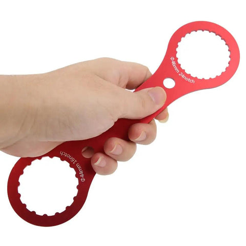Hand holding a Durable Aluminum BB Wrench Tool For 44mm And 46mm Bottom Brackets With 16 Notch And 24 Notch Easy Installation And Removal