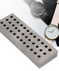 Heavy Duty Watch Staking Tool With Metal Plate 36 Holes Riveting Stake Set next to watches on desk