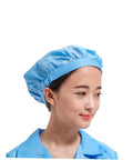 Heavy Duty 12 Pack Breathable Antistatic Mesh Work Caps For Adults And Super Comfy Dustproof Polyester Shop Hats With Quick Dry Panels. Woman wearing a blue mesh work cap.