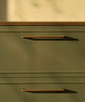 Close-up of Five Pack Antique Brass Cabinet Pulls, 7.56 Inch Hole Center Vintage Zinc Alloy Handles on green kitchen drawer.