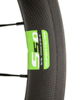 Detail of 50mm Carbon Road Wheelset 700C Clincher With 23mm Inner Width, Toray T700 Carbon Fiber, showing white and green decals