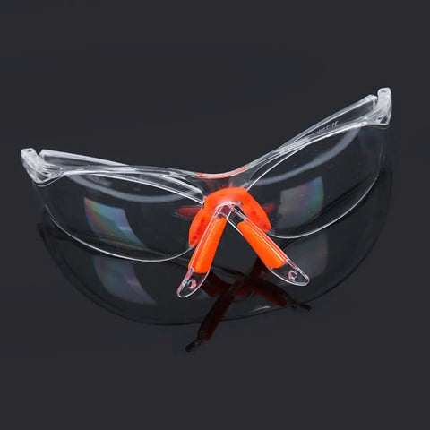 Four Pack Real Deal Fogless Safety Glasses With Thick Padding And Rounded Edges Windproof Splash Goggles Built Tough For Construction Carpentry And Garage Work Heavy Duty Kick Safe Eye Gear That Stays Totally Crystal Clear All Day, transparent goggles with orange padding.