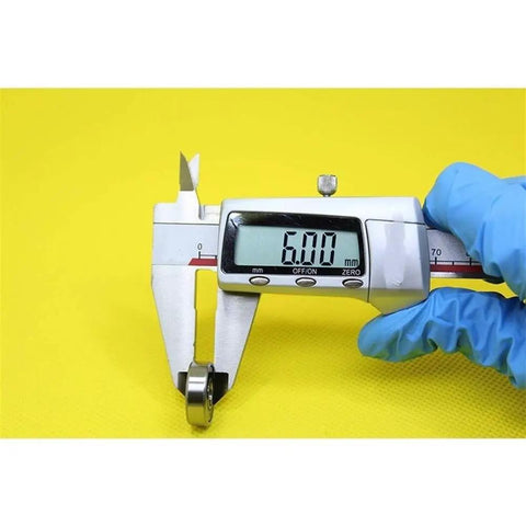 Measuring Heavy Duty 607 Hybrid Ceramic Ball Bearings With Si3N4 Balls, diameter 6mm, using digital caliper for precision.