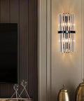 Top Shelf Crystal Wall Sconces With Brushed Black Metal And Sleek Bedroom Vanity Light For Bathroom Fixture Modern Bedside Lamp For Dining Room Decor Heavy Duty Build With Fresh Vibes mounted beside a TV in a stylish room.