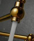 Close-up of Brass Pot Filler Faucet Wall Mount With Folding Double Joint Swing Arms Titanium Gold Finish showing water flow.