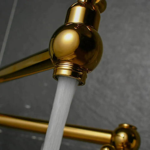 Close-up of Brass Pot Filler Faucet Wall Mount With Folding Double Joint Swing Arms Titanium Gold Finish showing water flow.