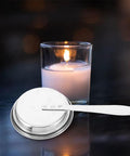 Stainless Steel Candle Snuffer With Handle, Multi Functional Fire Safety Tool for Candles Oil Lamps and Aromatherapy shown next to lit candle