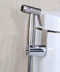 Stainless steel handheld bidet spray kit with shower diverter valve installed on toilet