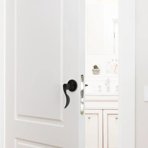 Quiet Operation Matte Black Door Lever Handle with Silent Technology and Wave Style Privacy Lock on a white interior door