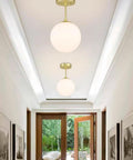 Semi Flush Mount Ceiling Light With Globe White Shade In Satin Brass Finish 1 Light Modern Fixture For Living Room And Dining Room With Chic Contemporary Vibe Close To Ceiling Design installed in hallway