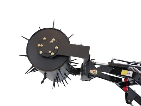 Close-up of a lawn scarifier attachment on Stomp Mini Skid Steer Loader With 1800 Lb Capacity for small jobs and landscaping.