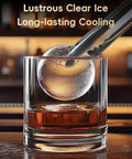 Countertop Ice Maker Machine Portable Sphere Creator Unit With Auto Self Cleaning And Responsive Touch Panel For Fast No Sweat Daily Batch Production At Home Bars And Weekend Sessions Party Ready Style, showcasing a clear spherical ice cube being placed in a drink.