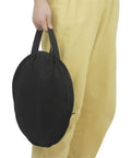 Person holding Hella Tough Octopus Practice Pad Storage Bag For 10 Inch Dumb Drum in black oxford cloth.