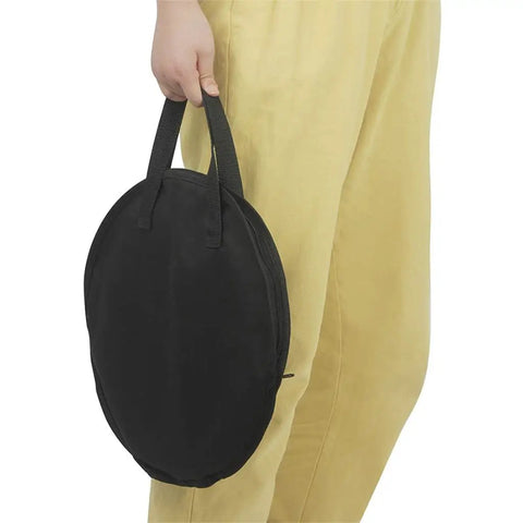 Person holding Hella Tough Octopus Practice Pad Storage Bag For 10 Inch Dumb Drum in black oxford cloth.