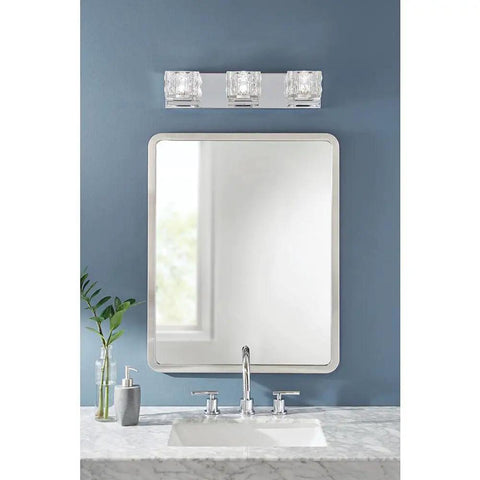 3 Light Sleek Chrome Integrated LED Vanity Light With Clear Cube Glass above bathroom mirror on blue wall