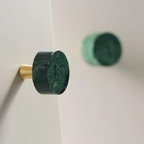 Six Pack 30mm Green Marble Cabinet Knobs With Brushed Brass Base mounted on a sleek surface, showcasing round natural stone design.