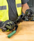 Heavy Duty Hydraulic Knockout Kit With Quick Draw Driver For 0.5 To 2 Inch Holes in use by an electrician on a workbench.