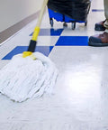 Mop in action on shiny floor, applying Heavy Duty Wet Look Floor Polish Bringing That Sleek High Gloss Shine And Solid Non Slip Shield For Busy Retail Spots And School Lobbies Keeps Flooring Looking Fresh Legit Tough While This Heavy Duty Gallon Hits Different On Scuffs.