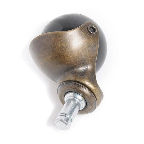 Smooth Gliding Antique Bronze PP Caster Wheels 4 Pack Swivel Ball Casters For Gaming Chairs Tables And Home Furniture Low Pile Carpet Solid Build Top Shelf Replacement Setup close-up view of bronze ball caster with black shell