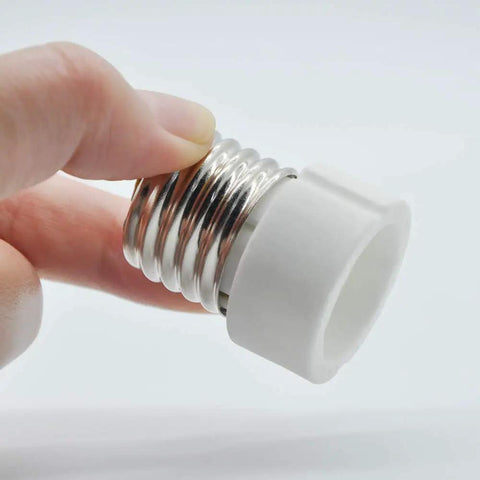 Hand holding E26 E27 To GU10 Ceramic Socket Adapter Built Tough For Heavy Duty Halogen And Led Spotlight Work.