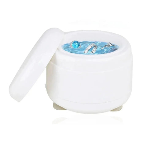 Premium Portable Ultrasonic Cleaner For Jewelry And Watches with rings submerged in water, compact white design for safe cleaning.
