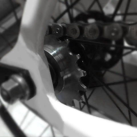 Close-up of Beefy Steel Freewheel For Fixed Gear Bikes With Lockring, 13T cog installed on a bike wheel for smooth power transfer.