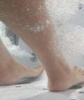 Foot submerged in bubbles from Sleek 32X52 Acrylic Transfer Walk In Tub With Heavy Duty Hydro Massage and Microbubble Jets.