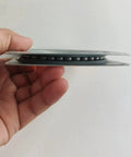 Close-up side view of a hand holding a galvanized steel Two Pack 4 Inch Square Lazy Susan Turntable Bearings Heavy Duty Swivel Plate Rustproof 95mm Square.